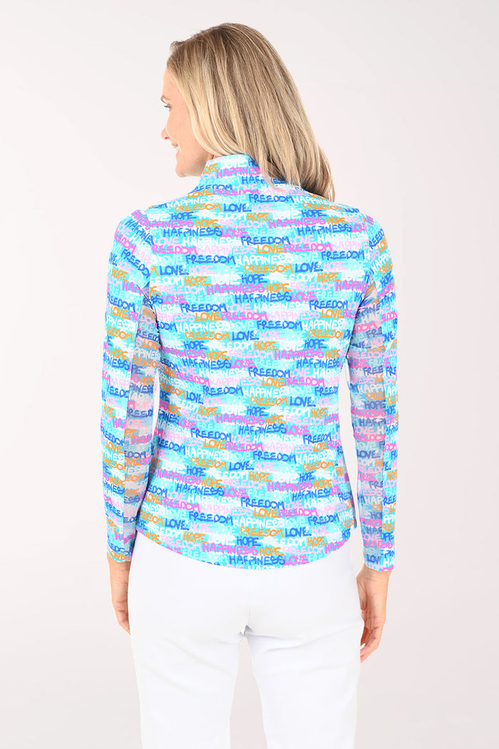 Woman wearing a colorful patterned shirt with text on a white background