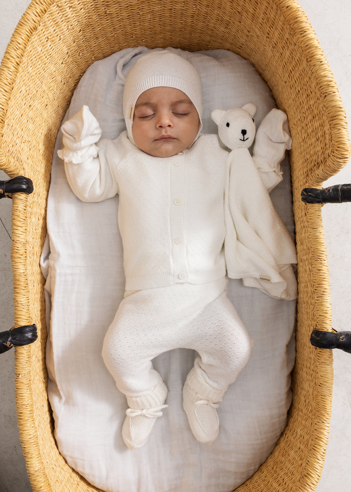 White stripe lining on newborn in white jumpsuit