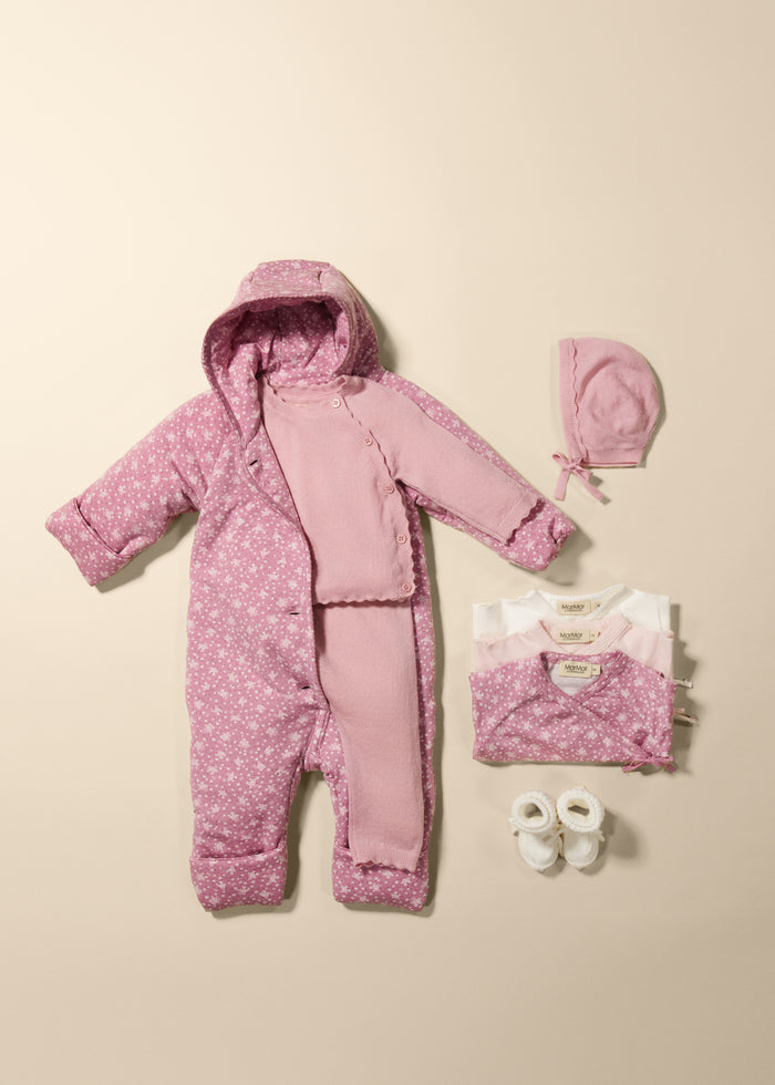 Baby set with pink jumpsuit and white knit socks.