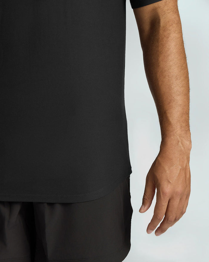 Person wearing a black t-shirt and shorts on a light gray background