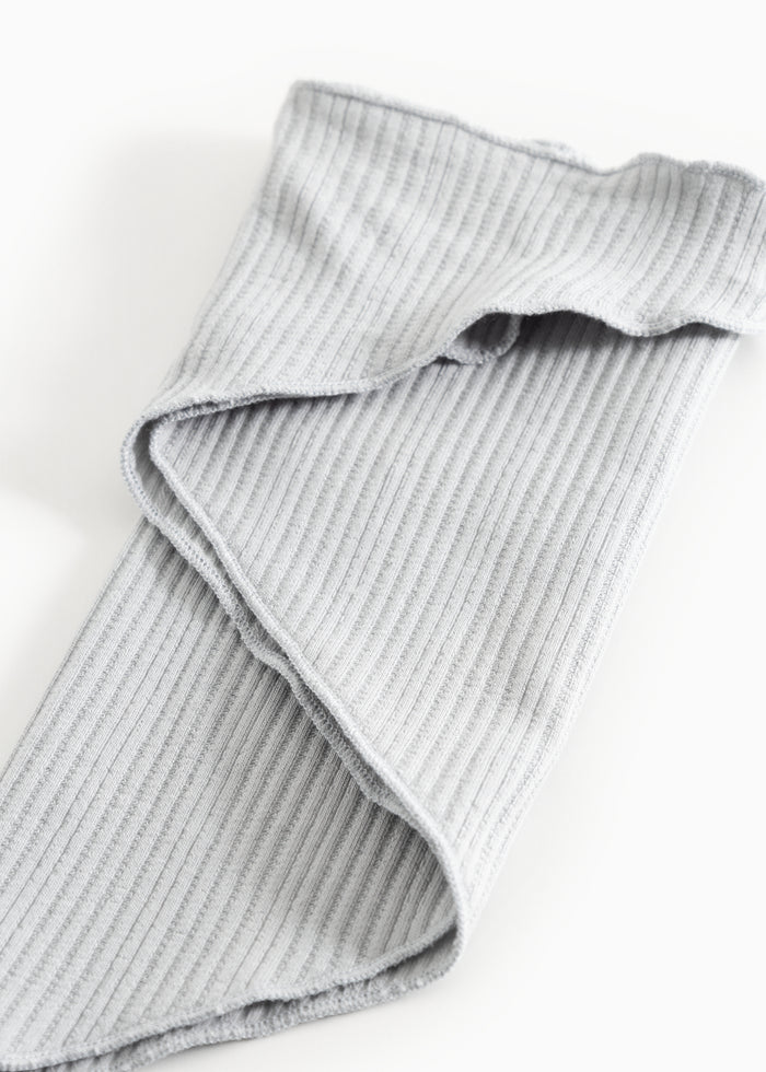 Striped baby blanket with a curved edge and stitching.