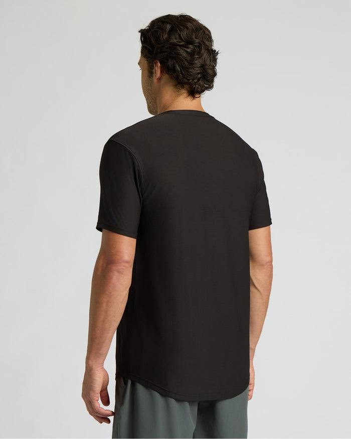 Man wearing a black t-shirt on a light gray background