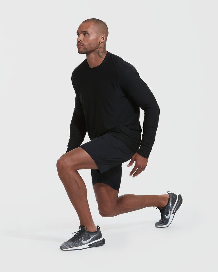 Man performing lunge in Black Active Long Sleeve Crew Neck T-Shirt.