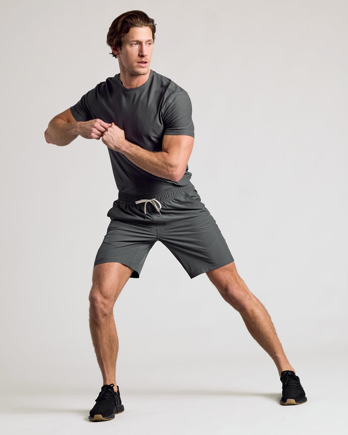 Man wearing 9 All Carbon Active Quick Dry Shorts 2-Pack in athletic pose.