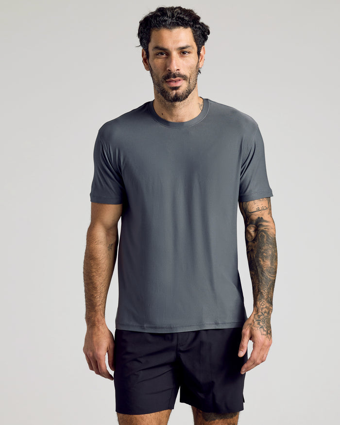 Man wearing Carbon Active Crew Neck Tee and black athletic shorts.