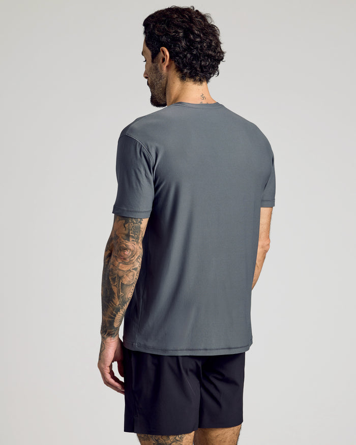Carbon Active Crew Neck Tee worn by man with tattoos, rear view.