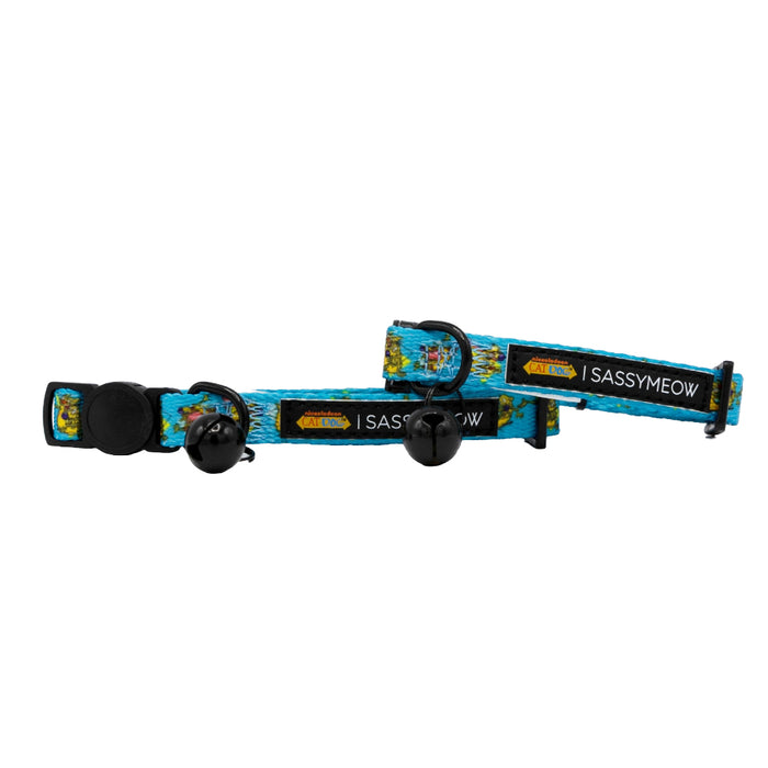 Two blue adjustable Cat Collar - Nickelodeon CatDog™ by Sassy Woof, featuring cartoon designs, black buckles, bells, and SASSYMEOW tags. The playful collars overlap on a white background.