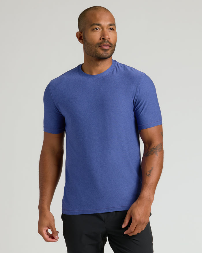Cosmos Active Crew Neck Tee worn by tattooed man in black pants.