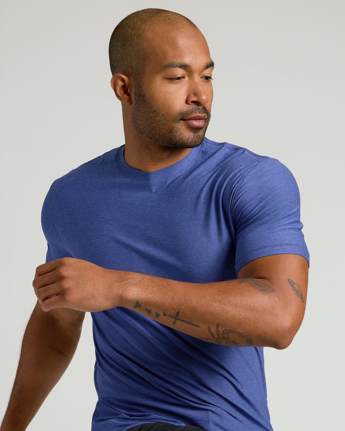 Man wearing Cosmos Active Crew Neck Tee, showcasing tattoos.