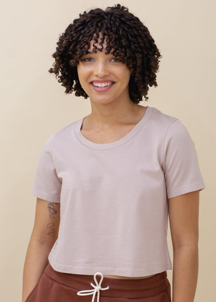 woman wearing cropped tee with open neck in pink
