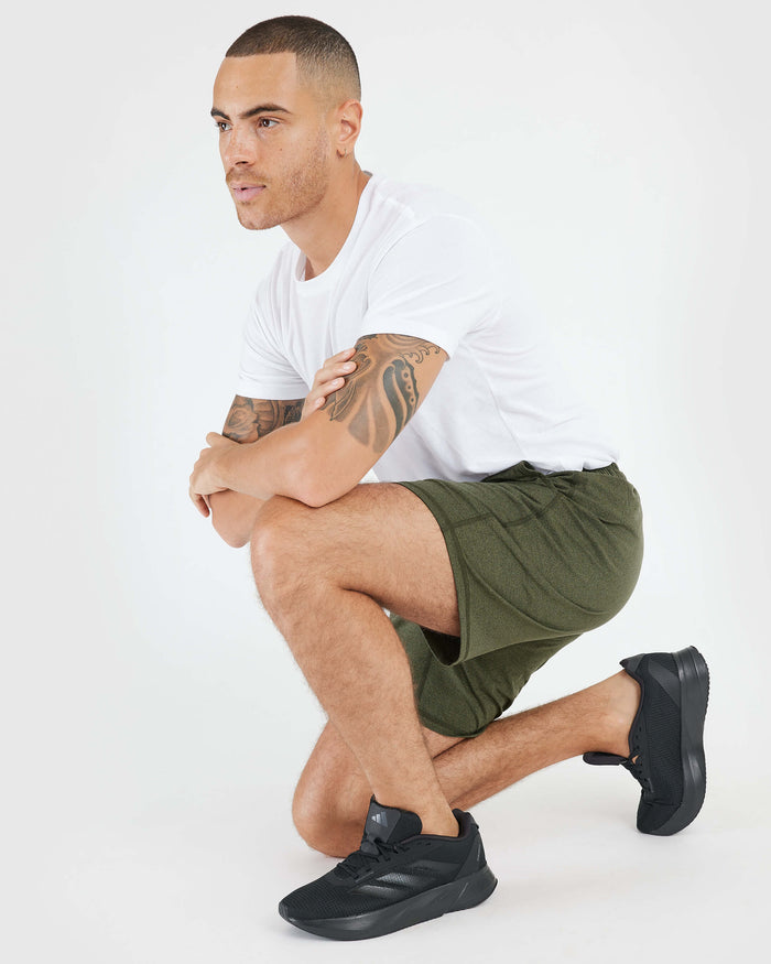 Man in Dark Heather Military Green Active Comfort Short kneeling.