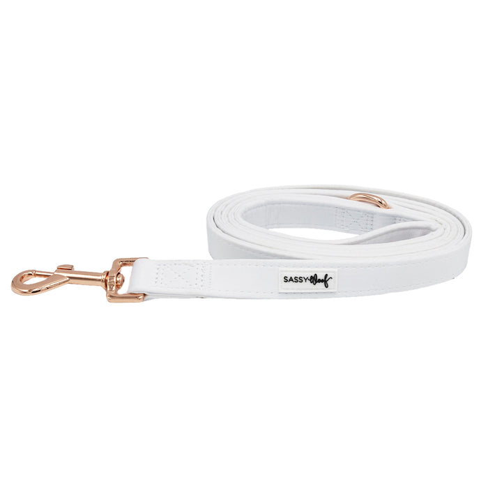 The Sassy Woof 'Dog Leash - Pup of Honor' features white satin, a rose gold clasp, a SASSY tag near the comfy neoprene handle, and is shown neatly coiled on white—ideal for matching your dog's accessories.