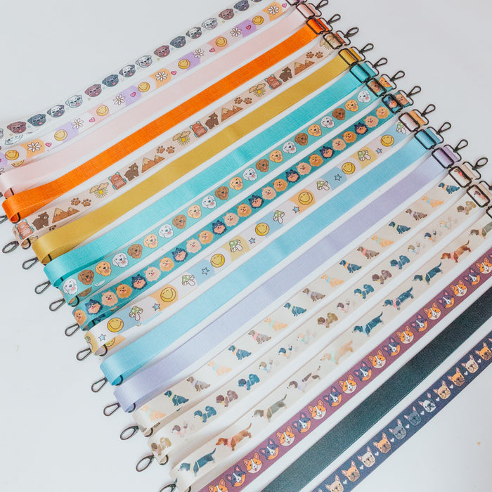 The Sassy Woof Dog Parent Bag - Strap Only features colorful, adjustable straps with playful cartoon animal and object designs, neatly arranged on a white background.