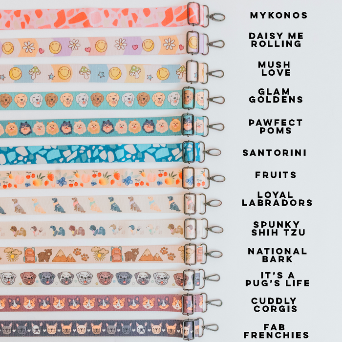 Twelve Dog Parent Bag straps by Sassy Woof, each with adjustable length and vibrant patterns—including names like “MYKONOS,” “DAISY ME ROLLING,” and “CUDDLY CORGIS”—are displayed in a row, labeled on the right.