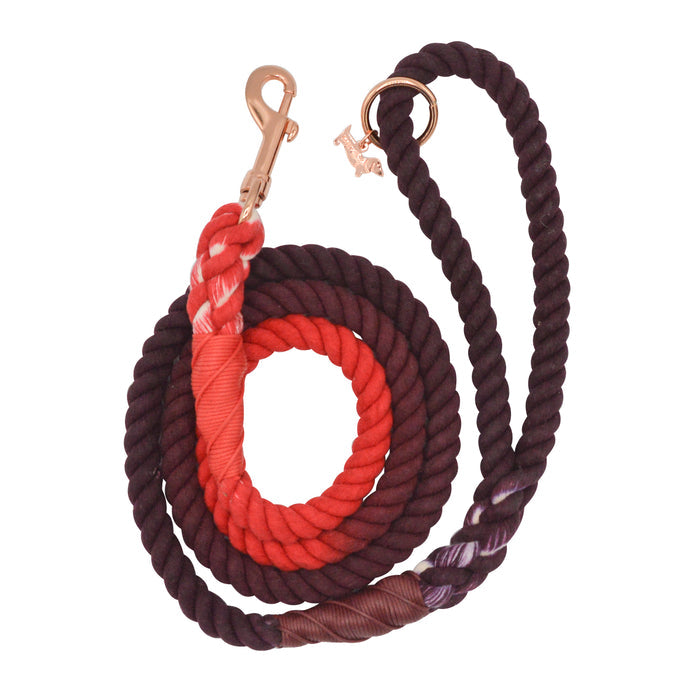 The Sassy Woof Dog Rope Leash - Ruby is a coiled cotton leash with maroon and red sections, wrapped in colored thread, and finished with a gold metal clip.
