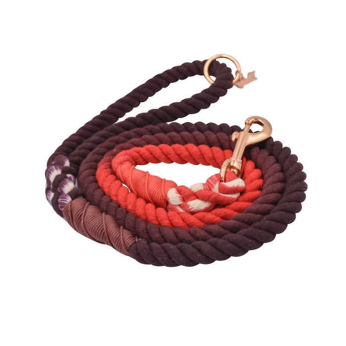 The Sassy Woof Dog Rope Leash - Ruby features a coiled cotton rope with dark purple, red, and pink sections, rose gold clasp, and decorative wrapped thread accents.