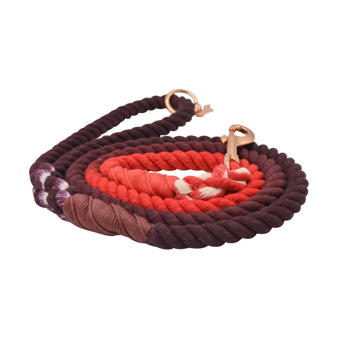 The Sassy Woof Dog Rope Leash - Ruby features color gradients from dark purple to red, sturdy metal clasps, and reinforced wrapped ends for strength, shown against a white background.