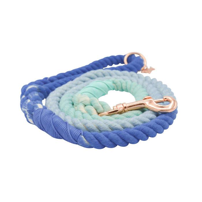 The Sassy Woof Dog Rope Leash - Tropic features hand-crafted ombre blue and teal cotton with a rose gold clasp, shown coiled on a white background.