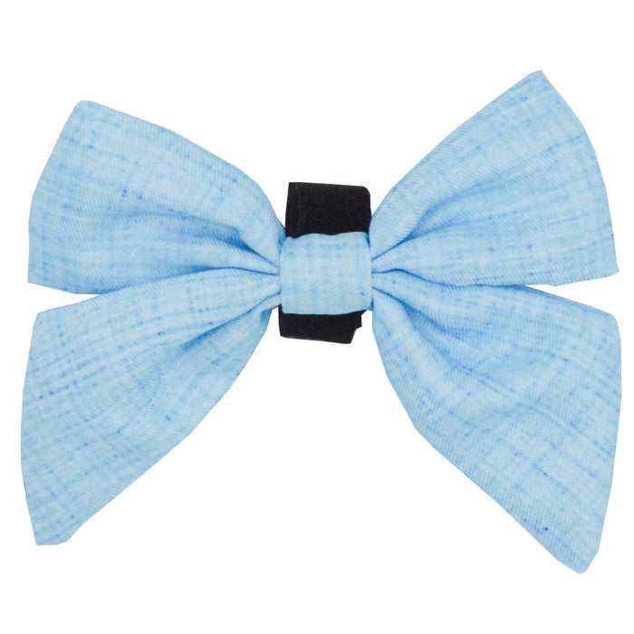 The Sassy Woof Dog Sailor Bow - Blumond features a light blue fabric with subtle dark speckles, tied on a black elastic band, displayed against a white background.