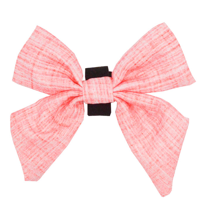 The Sassy Woof Dog Sailor Bow - Dolce Rose features a large pink textured fabric bow, tied with a black center band—ideal as a playful dog accessory or chic sailor bow, shown on a white background.