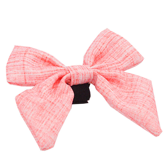 The Sassy Woof Dog Sailor Bow - Dolce Rose features pink fabric with a black center, subtle stripes, and two wide pointed tails—a stylish accessory for your pup.