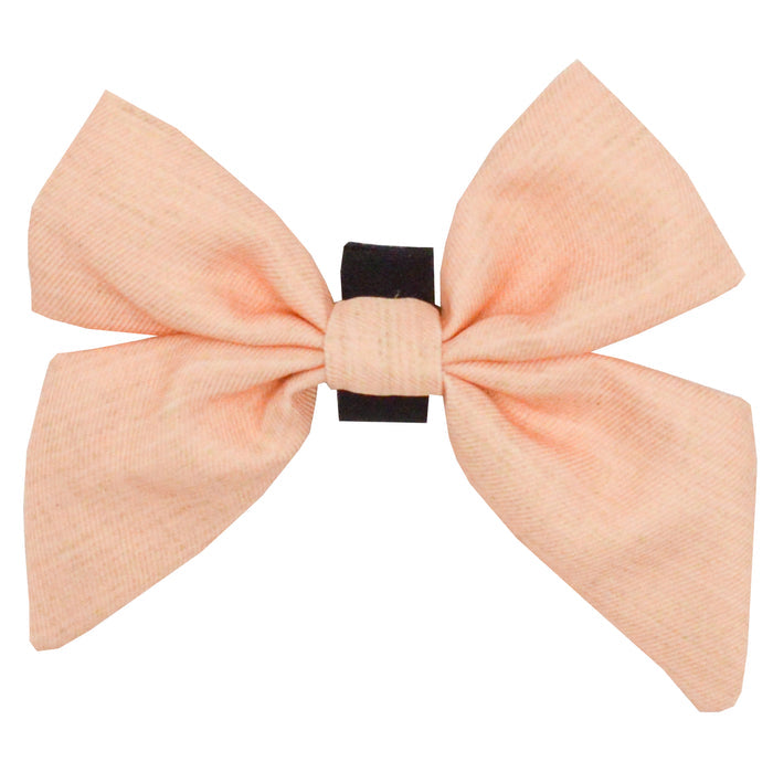 The Sassy Woof Dog Sailor Bow - Pinot is a large, light pink bow with a black elastic band from the Pinot collection, shown against a white background.