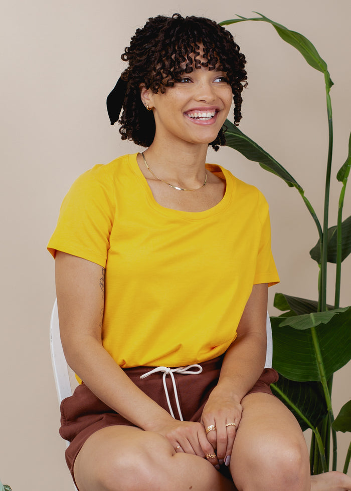 woman wearing relaxed crewneck tee in gold