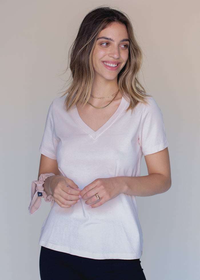 woman wearing light pink vneck tee