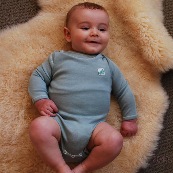 Merino wool long sleeved babies’ bodysuit in blue.
