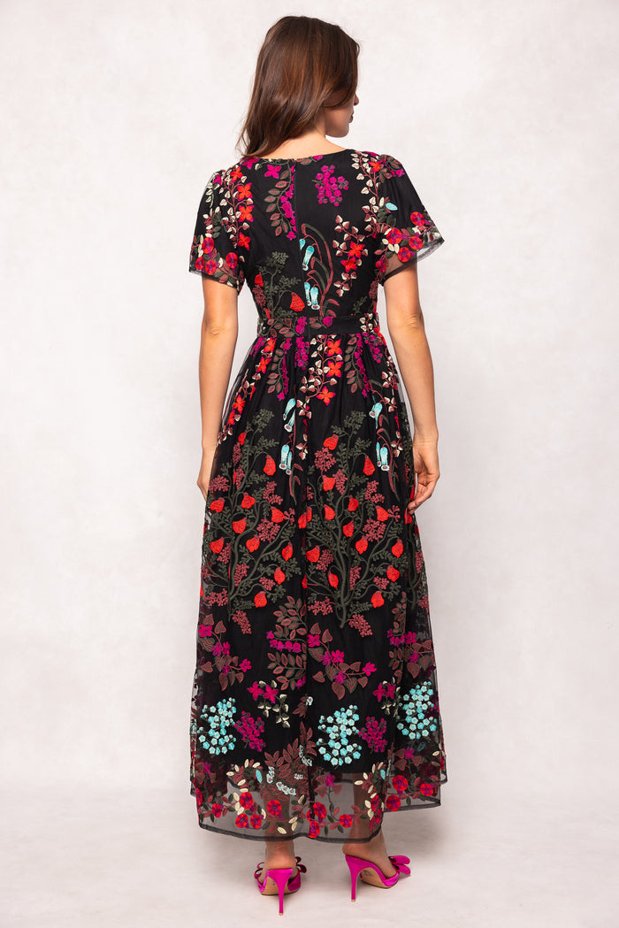 Woman wearing a floral dress with a white background