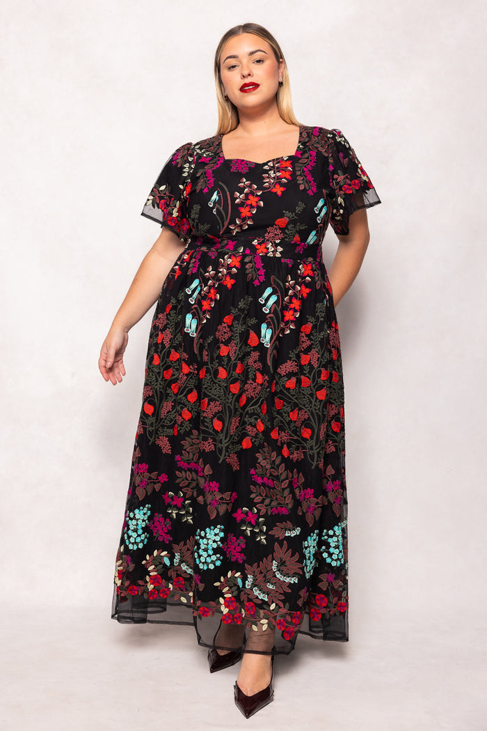 Woman wearing a floral dress with a white background