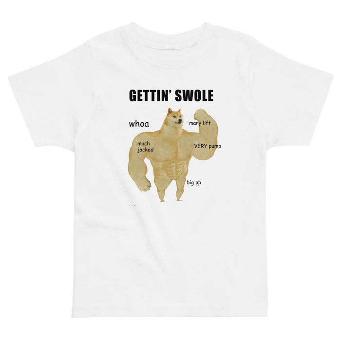 Gettin Swole Doge Kid's Tee - The jarring juxtaposition of the stoic biscuit-colored Shiba Inu head (#E5C27D) atop a hyper-defined human muscular physique accompanied by "much/many" modifiers, all in high-contrast obsidian text (#000000) against a mottled ash grey base (#C0C0C0).