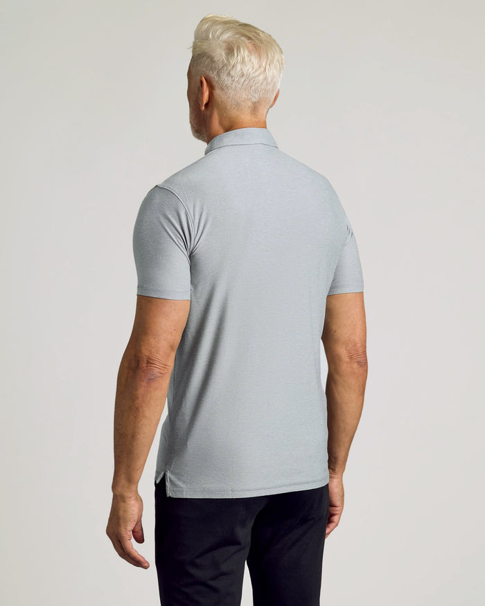 Man wearing Heather Light Gray Active Polo, showcasing back view with side hem vent.