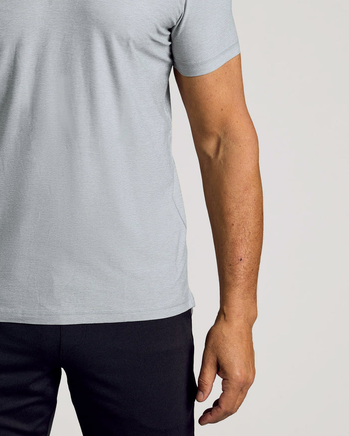 Heather Light Gray Active Polo worn with dark pants, showcasing relaxed fit.