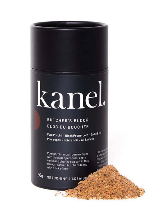Black Cylindrical package of Kanel seasoning with a pile of spices beside it.