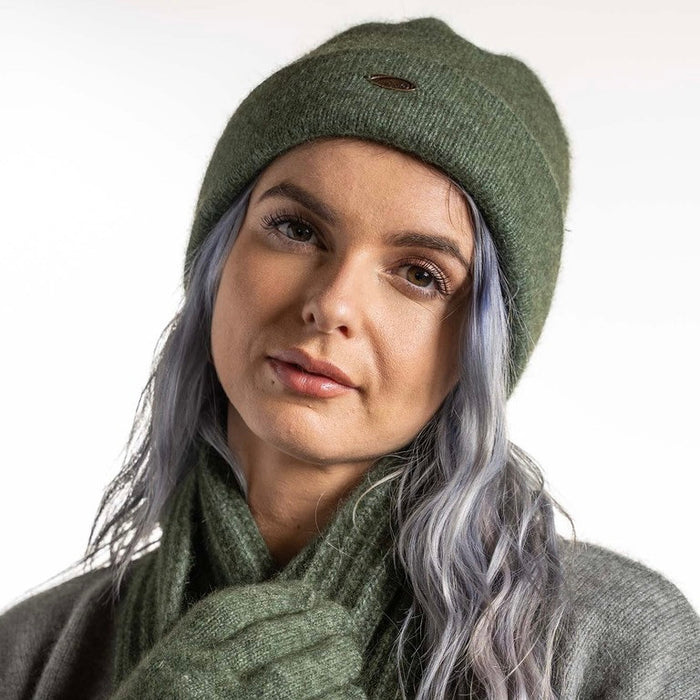 A woman wearing an Moss-coloured Koru Merino and Possum Plain Beanie.