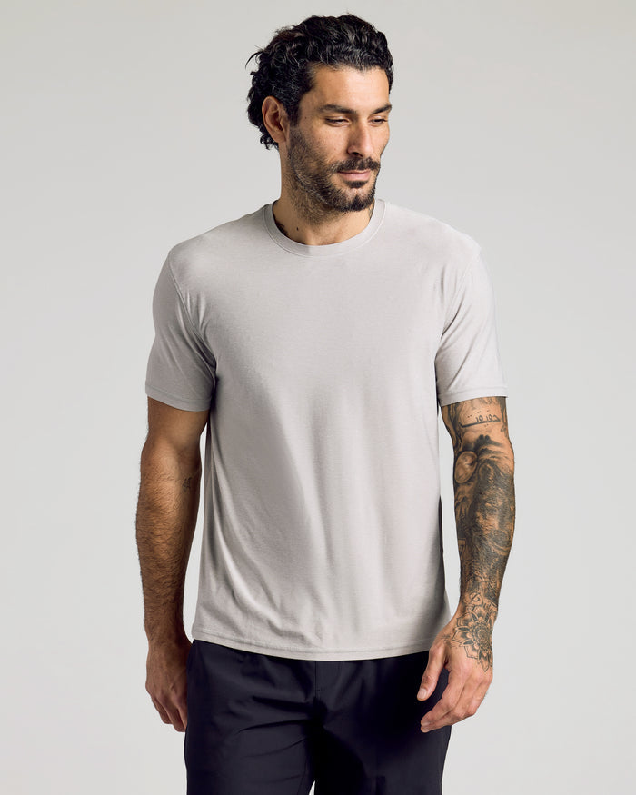 Man wearing Light Heather Gray Active Crew Neck Tee with tattooed arm visible.