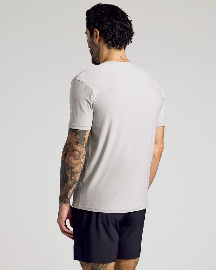 Man wearing Light Heather Gray Active Crew Neck Tee, showcasing back and tattoos.