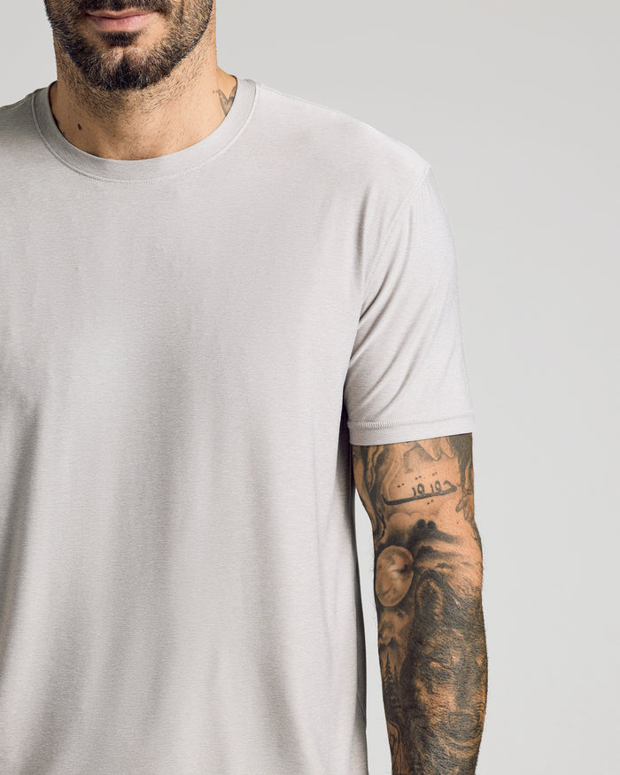 Light Heather Gray Active Crew Neck Tee on a tattooed man's torso.