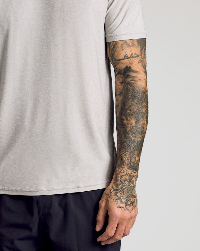 Light Heather Gray Active Crew Neck Tee on tattooed arm and torso.