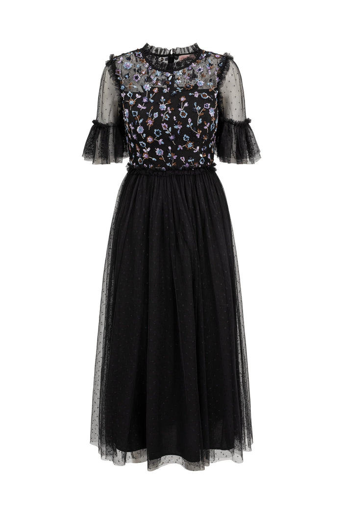 Black dress with floral patterned top on a white background