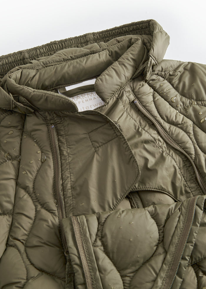 The jacket is made of dark olive with a strong zipper and hood.