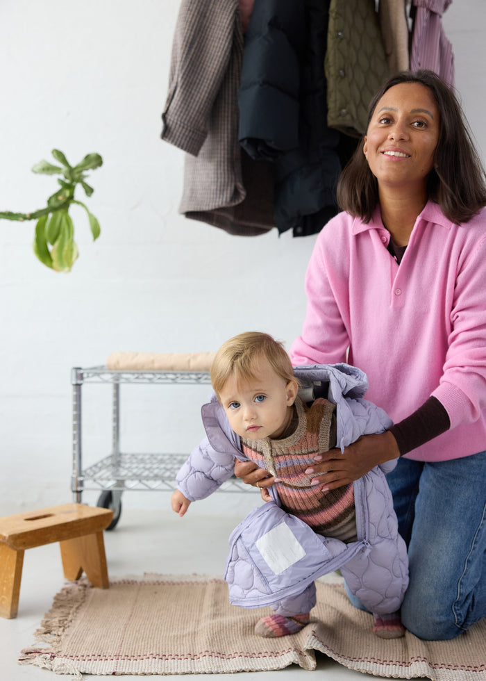 Lavender-colored dress for children, quilted fabric and hood in the same color.