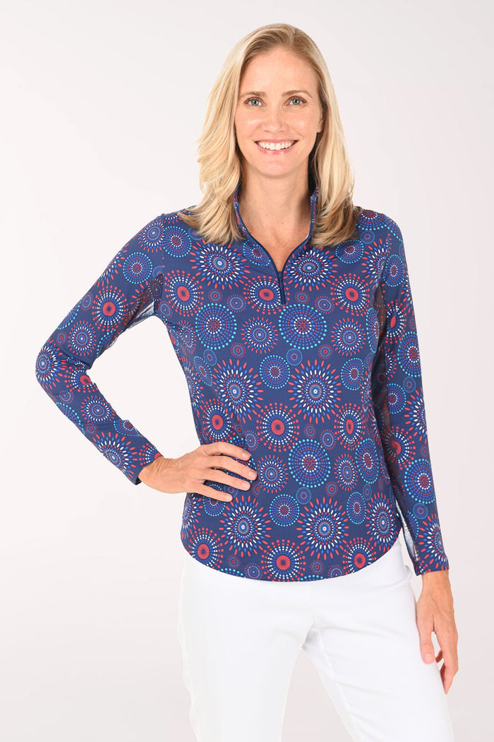 Woman wearing a blue patterned long-sleeve shirt on a white background
