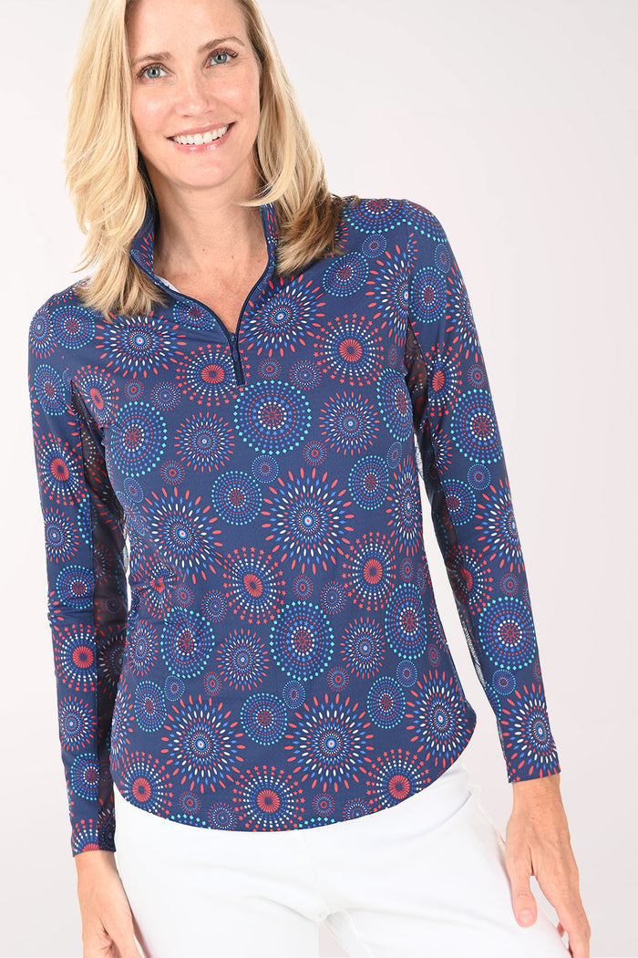 Woman wearing a blue patterned long-sleeve shirt on a white background