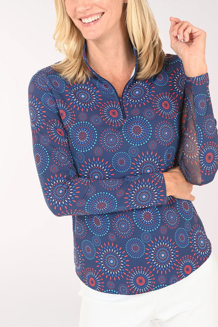 Woman wearing a blue patterned long-sleeve shirt on a white background