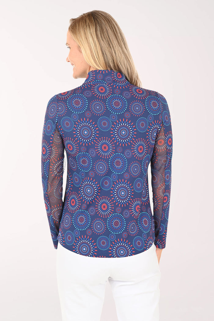 Woman wearing a blue patterned long-sleeve shirt on a white background