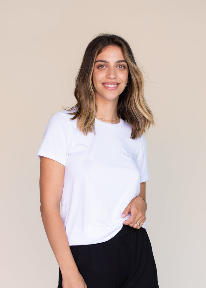 woman wearing white tee shirt and black pants