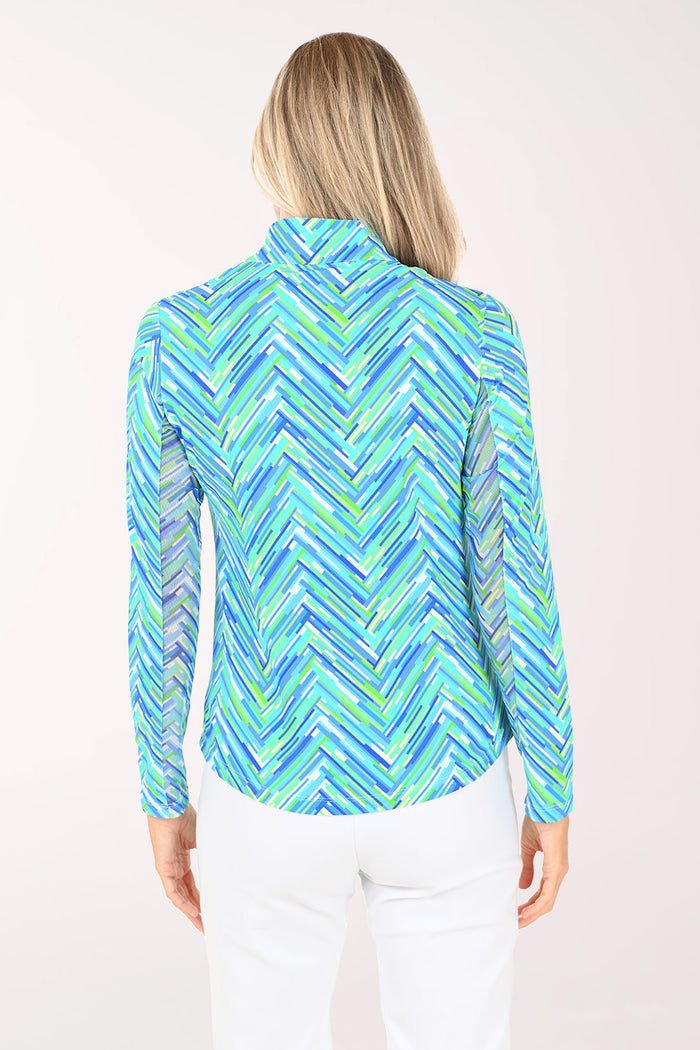 Woman wearing a blue and green patterned long-sleeve shirt on a white background