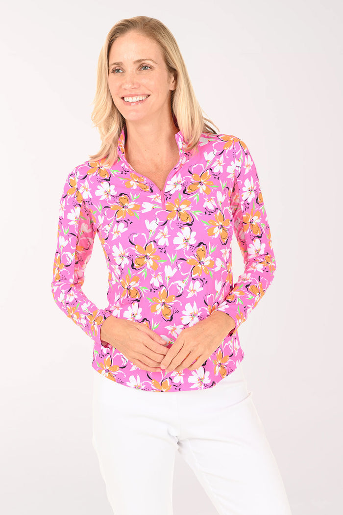 Woman wearing a pink floral long-sleeve shirt on a white background